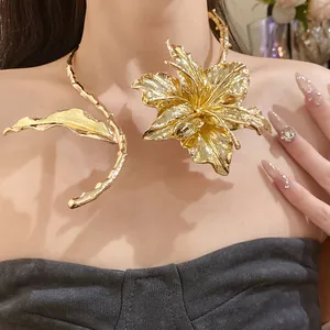 Macro view of a luxury gold metal flower and leaf pleated statement choker