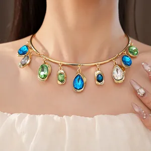 Detail view of a luxury gold-tone choker with colorful teardrop and oval crystal pendants
