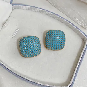 Elegant turquoise blue square geometric stud earrings with gold grid and zircon accents.