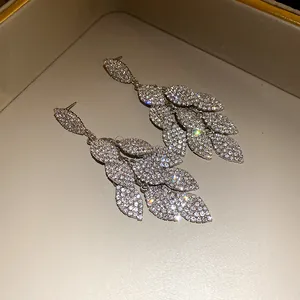 Close-up showing the brilliant sparkle of these dense crystal leaf tassel earrings.