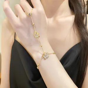 Close-up view of an elegant 14k gold-plated flower finger bracelet with sparkling zircons