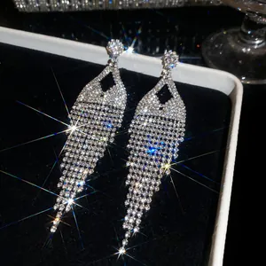 Close-up of sparkling rhinestone fringe earrings with heavy-duty crystal craftwork