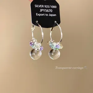 Detailed view of sweet colorful transparent glass ball hoop earrings made of 925 silver