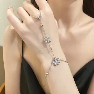 Detailed view of a zircon flower hand chain bracelet with an integrated ring.