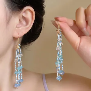 Élégantes boucles d'oreilles à pampilles en perles d'étoile de mer pour les vacances.