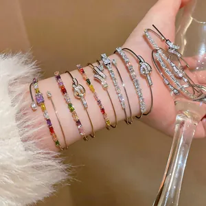 Detail showing 18k gold plated open bangles with colorful square zircons on wrist