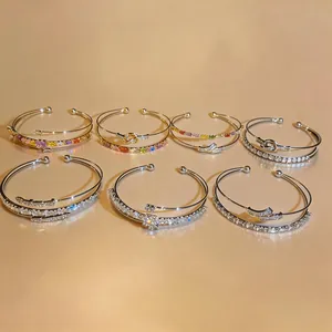Detailed view of luxury 18k gold plated open bangles with sparkling cubic zirconia
