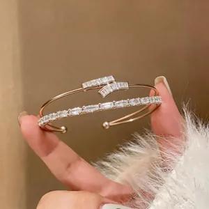 Detail shot of elegant 18k gold plated open cuff bracelet with sparkling square zircons