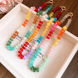 Detailed macro view of colorful dopamine-style rainbow acrylic beaded necklaces in a tray