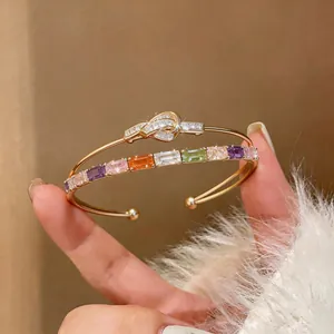 Detailed view of 18k gold-plated bangle featuring colorful square zircons and knot design