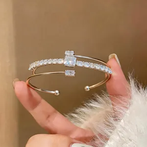 Close-up of 18k gold plated open bracelet featuring square and round brilliant zircons
