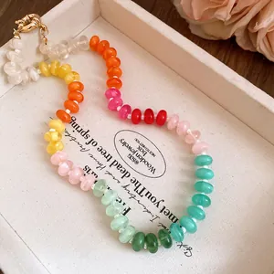 Close-up detail of a colorful rainbow acrylic beaded necklace with dopamine style vibes