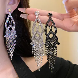 Detail showing three colors of shiny exaggerated rhinestone tassel statement dangle earrings.