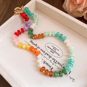 Close-up of colorful irregular acrylic beads on a vibrant rainbow choker necklace