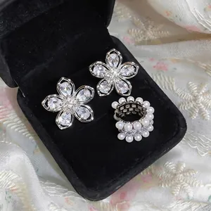 Elegant French style zircon flower ear clips and pearl ring displayed in a black velvet box