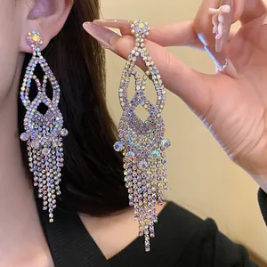 Detailed macro view of sparkling rhinestone hollow tassel chandelier earrings for women