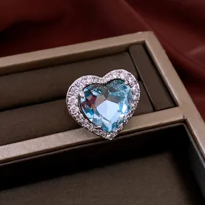 Vintage micro-pave heart-shaped open ring with sparkling light blue gemstone accent