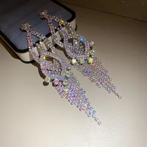 Detailed macro view of sparkling rhinestone tassel drop earrings with AB crystals.