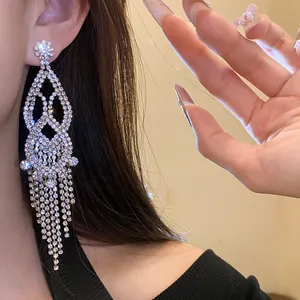 Detailed view of elegant silver drop earrings with shimmering rhinestone tassels