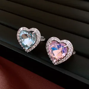 Macro view of heart-shaped open rings featuring sparkling micro-pave and colorful crystals.