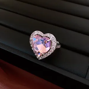 Close-up of a luxury vintage ring with a faceted pink heart zircon and micro-pave crystals