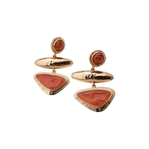 Retro vintage geometric earrings featuring gold textured metal and amber resin stones