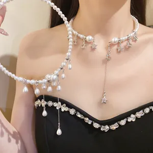 Close-up detail of a vintage pearl choker featuring elegant star charms and teardrop tassels.