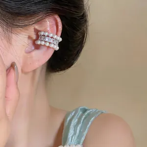 Elegant pearl and zirconia ear cuff worn on ear, French style non-pierced jewelry