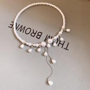 Close-up detail of a French vintage pearl choker with elegant teardrop tassels