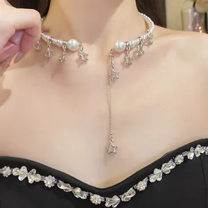 Detailed view of elegant pearl choker with dangling crystal star charms and tassel