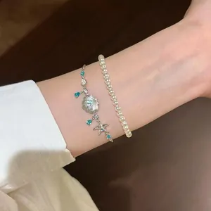 Elegant shell and starfish charm bracelet set with blue teardrop zircon and white pearls