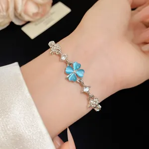 Detail view of the blue cat eye stone four-leaf clover bracelet with zircon accents