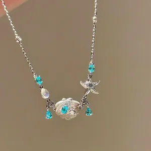 Elegant silver bracelet featuring sea shells starfish and blue teardrop cubic zirconia stones