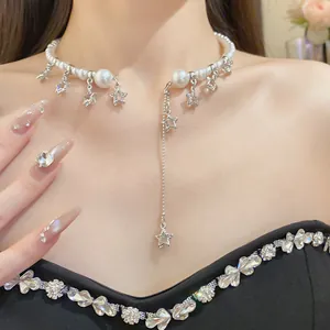 Elegant pearl choker necklace featuring dangling silver star charms and tassel on a model