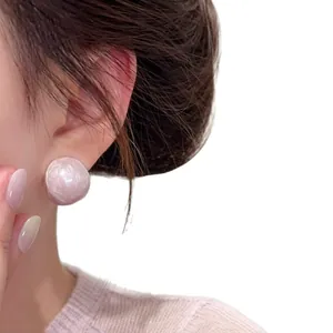 Elegant pale pink elliptical stud earrings with a glossy pearly finish for women