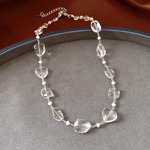 Macro view of clear crystal beads and white pearls on a minimalist adjustable necklace