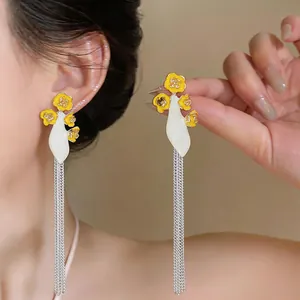 Long silver tassel earrings with yellow enamel flowers and white base detail