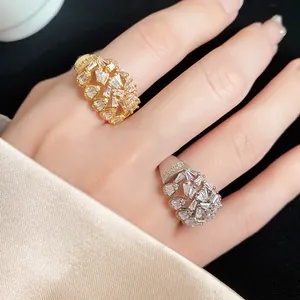 Close-up of 18k gold plated hollow-out open rings with sparkling zircons on fingers