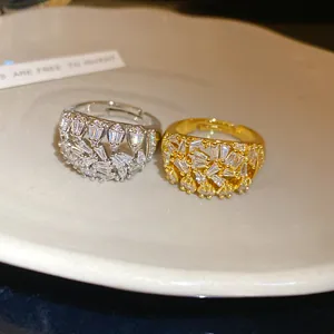 Detail view of 18k gold plated geometric hollow open rings with sparkling zircons