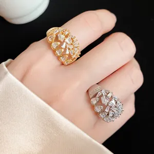Close-up of 18k gold plated hollow geometric rings with sparkling baguette zirconia