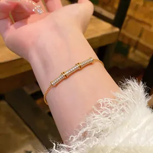 Close-up of 18k gold plated bamboo knot bracelet with sparkling pavé zircons on wrist.