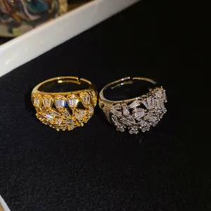 Close-up detail of luxury hollow-out rings with sparkling zircon in gold and silver finish