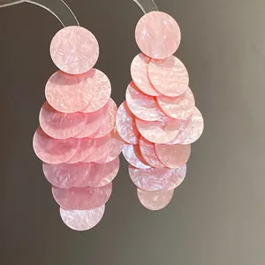 Detail view of elegant pink marbled acrylic tiered round petal tassel earrings for women