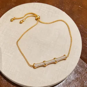 Exquisite detail of 18k gold-plated bamboo knot bracelet with shiny cubic zirconia stones