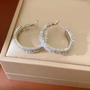 Elegant silver-toned hoop earrings pavé-set with sparkling cubic zirconia crystals