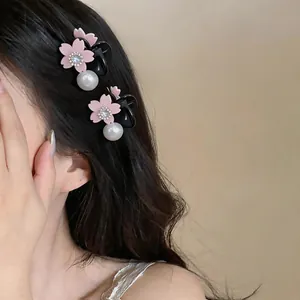 Elegant side view of a model wearing pink flower claw clips with dangling pearls
