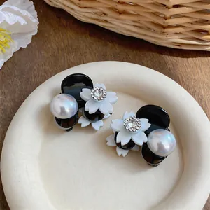 Elegant small flower hair claw clip with pearl and rhinestone details for girls