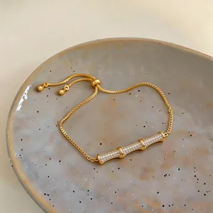Detailed macro view of 18k gold plated bamboo bar bracelet with sparkling zircons.