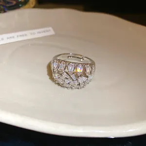 Detail of a geometric 18k gold plated ring with shimmering zirconia stones