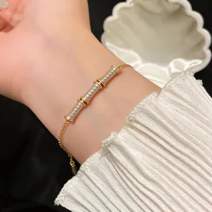 Close-up of elegant gold-plated bamboo joint bracelet set with sparkling zircons
